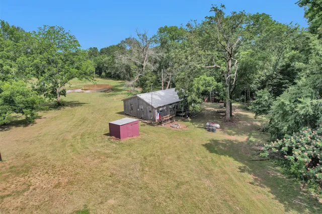 a view of a house with backyard porch and sitting area