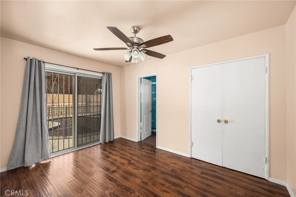 9085 Remick Avenue Arleta, CA 91331 - Photo 21 of 48 Primary bedroom with slider to backyard, door to attached bathroom and double door closet