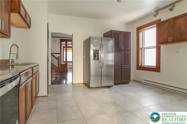 a kitchen with stainless steel appliances granite countertop a refrigerator and a sink