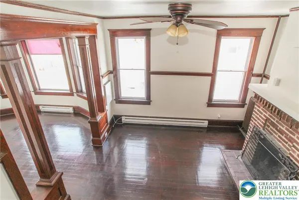 a view of an entryway with wooden floor and door