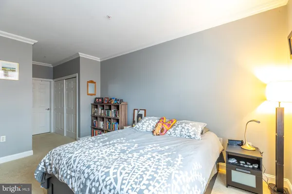 a bedroom with a bed and a dresser in it