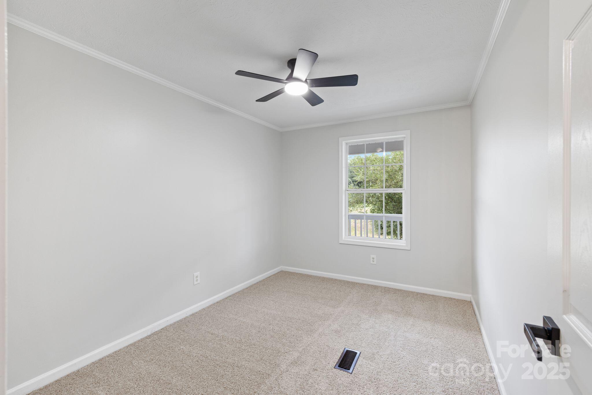 6708 Rebel Road Marshville, NC 28103 - Photo 23 of 41 an empty room with a window and a ceiling fan