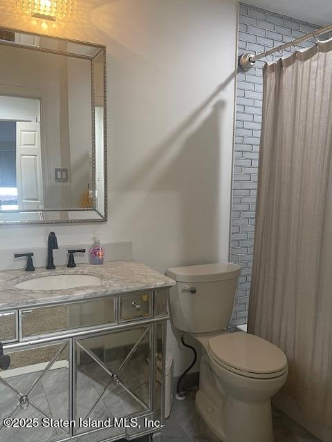 168 Jamie Lane Staten Island, NY 10312 - Photo 16 of 26 a bathroom with a granite countertop toilet sink and mirror
