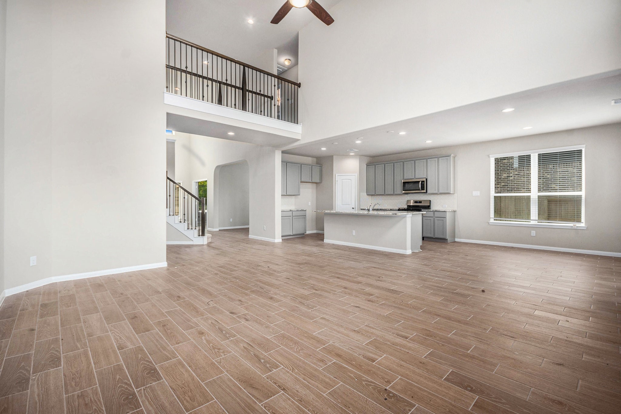 25 Carmel Drive Manvel, TX 77578 - Photo 12 of 50 a view of an empty room with window and wooden floor