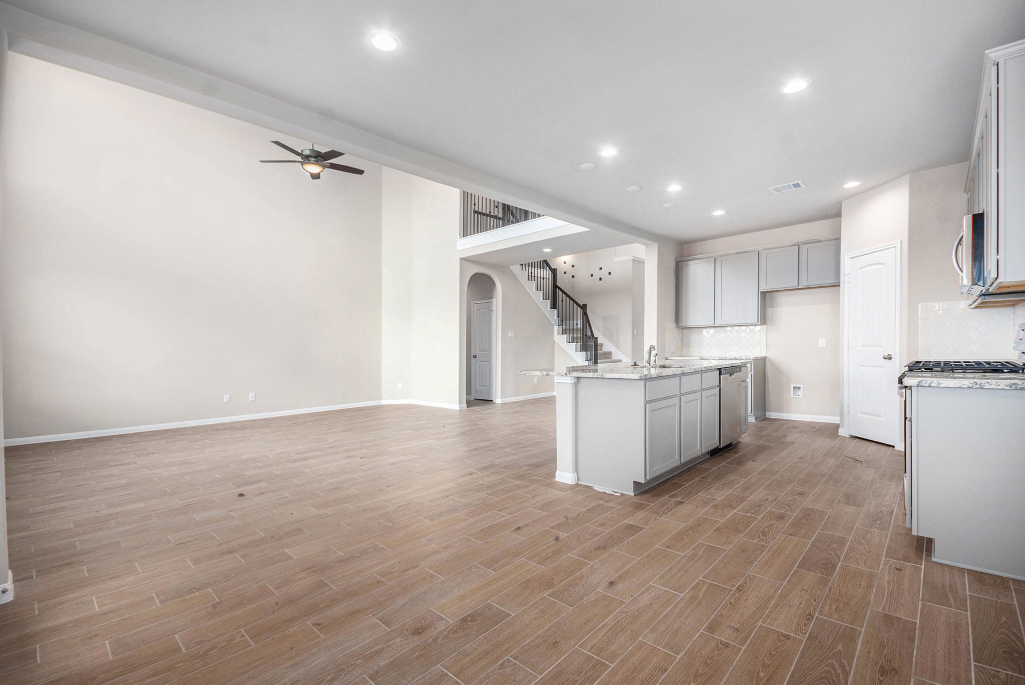 25 Carmel Drive Manvel, TX 77578 - Photo 15 of 50 a view of a kitchen with wooden floor and electronic appliances
