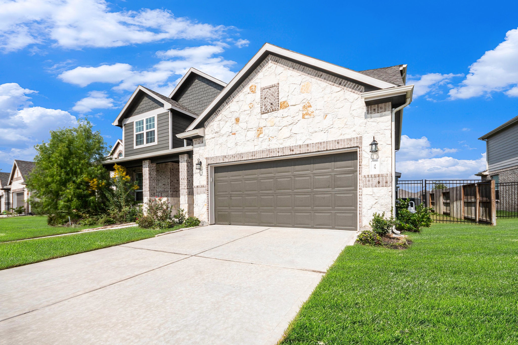 25 Carmel Drive Manvel, TX 77578 - Photo 2 of 50 a view of a white house with a small yard and large tree