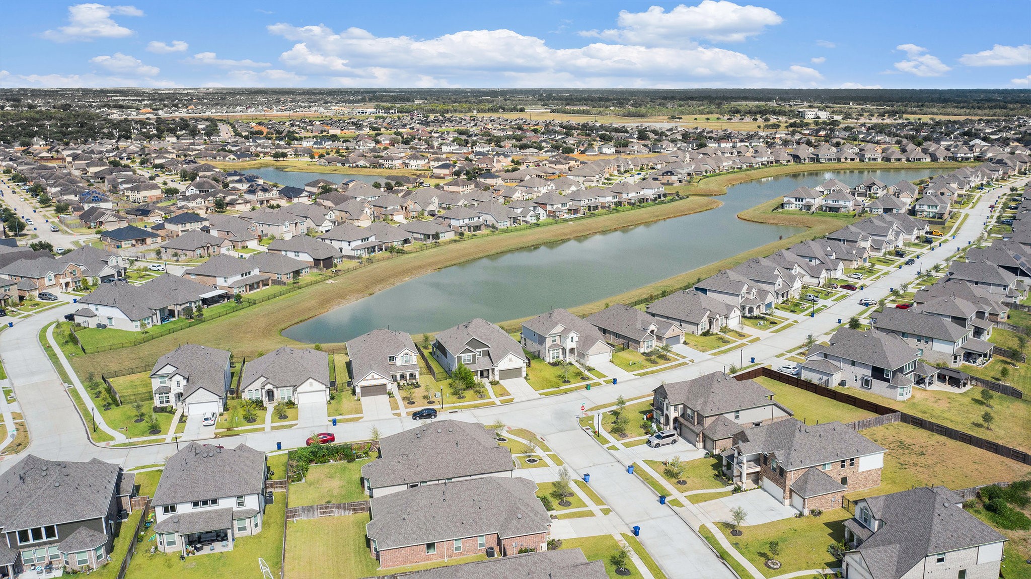 25 Carmel Drive Manvel, TX 77578 - Photo 42 of 50 an aerial view of a city and lake view