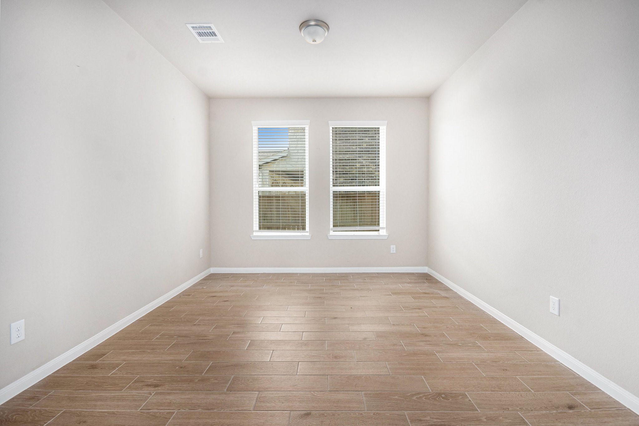 25 Carmel Drive Manvel, TX 77578 - Photo 9 of 50 an empty room with wooden floor and windows