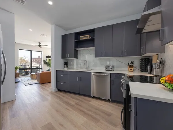 a kitchen with a sink a counter space cabinets and appliances