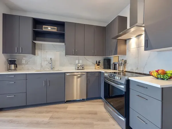 a kitchen with a sink a stove and cabinets