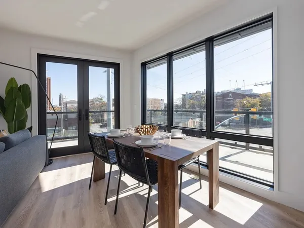 a dining room with furniture window and wooden floor