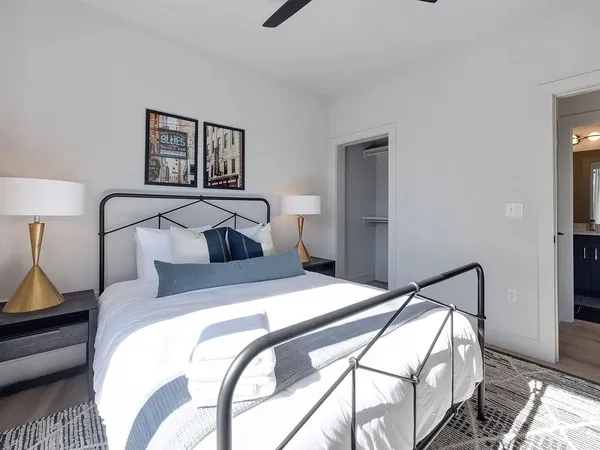 a bedroom with a bed and wooden floor