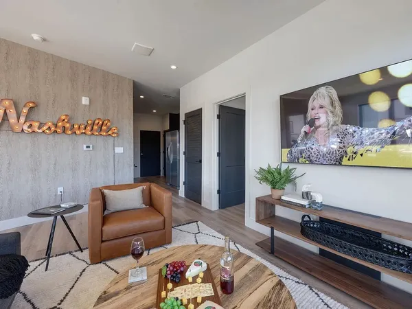 a living room with furniture and wooden floor