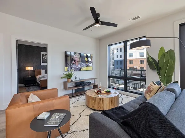 a living room with furniture and a wooden floor