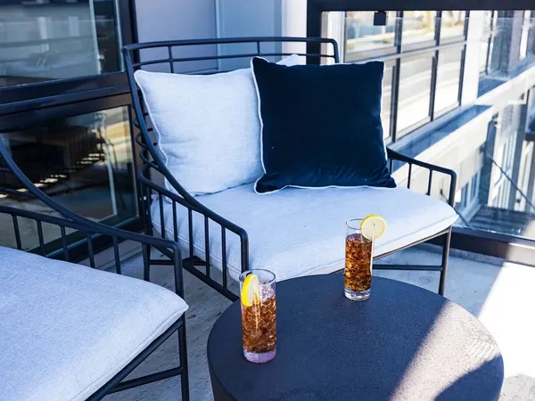 a view of balcony and dining area with furniture