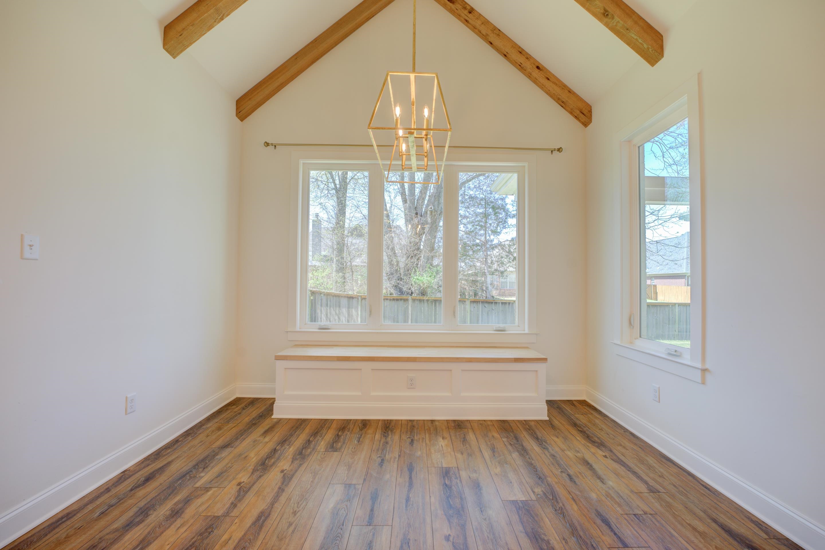 1373 Belfair Drive Collierville, TN 38017 - Photo 10 of 24 an empty room with wooden floor chandelier and windows