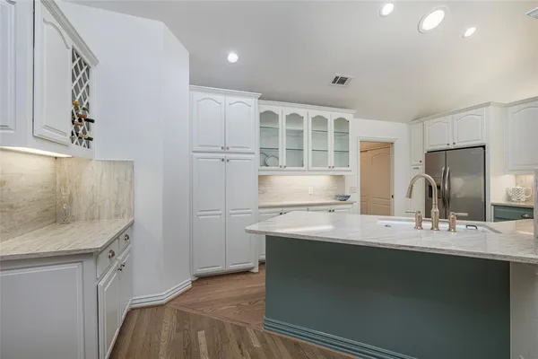 a kitchen with a sink appliances and cabinets