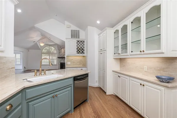 a kitchen with a sink cabinets and wooden floor