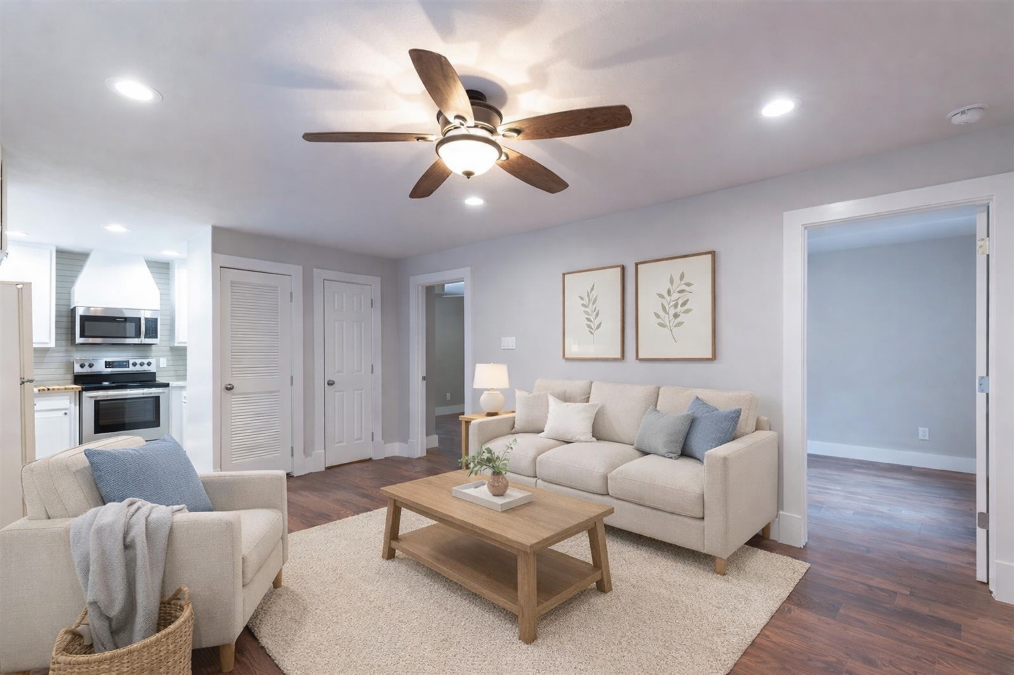 a living room with furniture and a wooden floor