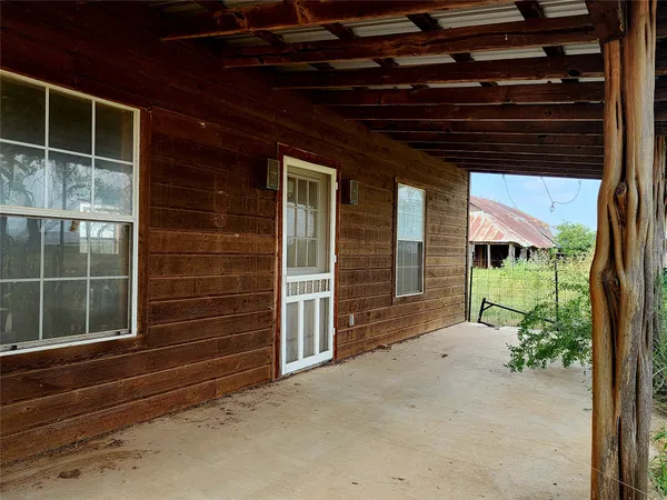 a front view of a house with a large window and a yard