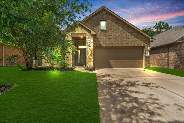 a front view of a house with a garden and yard