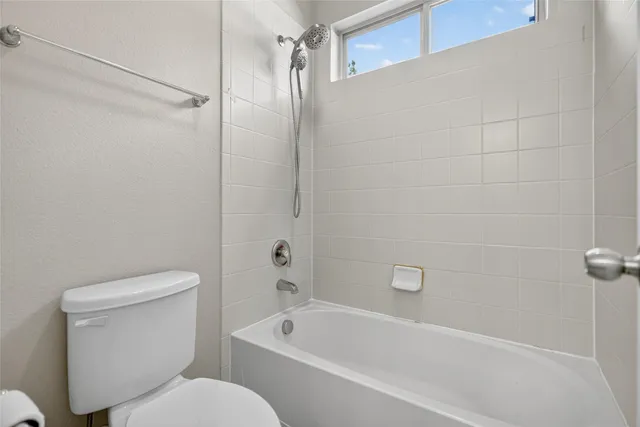 a bathroom with a toilet and a bathtub