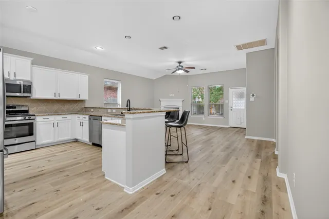 a kitchen with a table and chairs in it