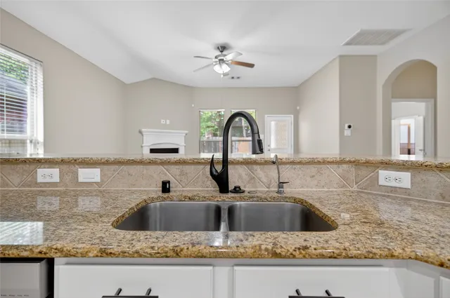 a kitchen with a sink a counter space and a counter top space