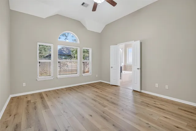 wooden floor in an empty room with a window