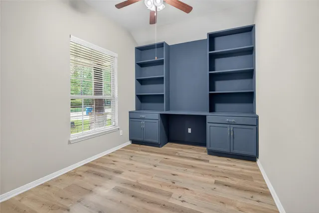 a view of an empty room with a cabinet and a window