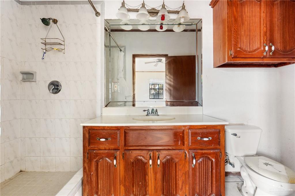 2300 Coby Drive Mission, TX 78574 - Photo 12 of 27 a bathroom with a sink a toilet and mirror