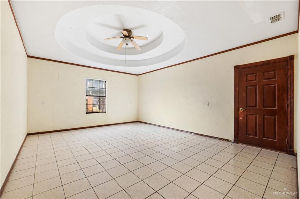 2300 Coby Drive Mission, TX 78574 - Photo 16 of 27 an empty room with windows and fan