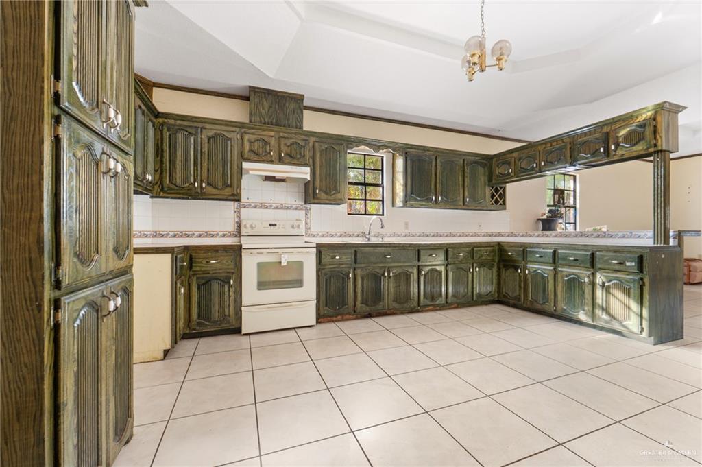 2300 Coby Drive Mission, TX 78574 - Photo 5 of 27 a kitchen with stainless steel appliances a stove sink and cabinets