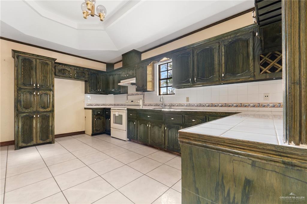 2300 Coby Drive Mission, TX 78574 - Photo 6 of 27 a kitchen with a sink a stove top oven and cabinets