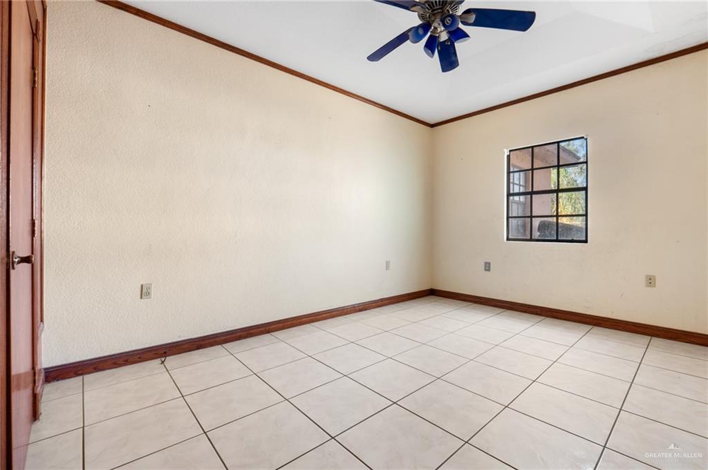 2300 Coby Drive Mission, TX 78574 - Photo 10 of 27 an empty room with windows and ceiling fan