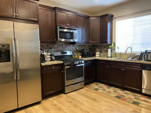 a kitchen with a sink stove and refrigerator