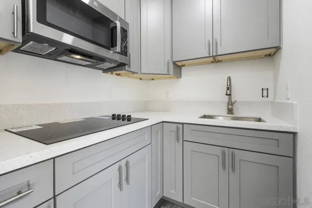 a kitchen with a sink and cabinets