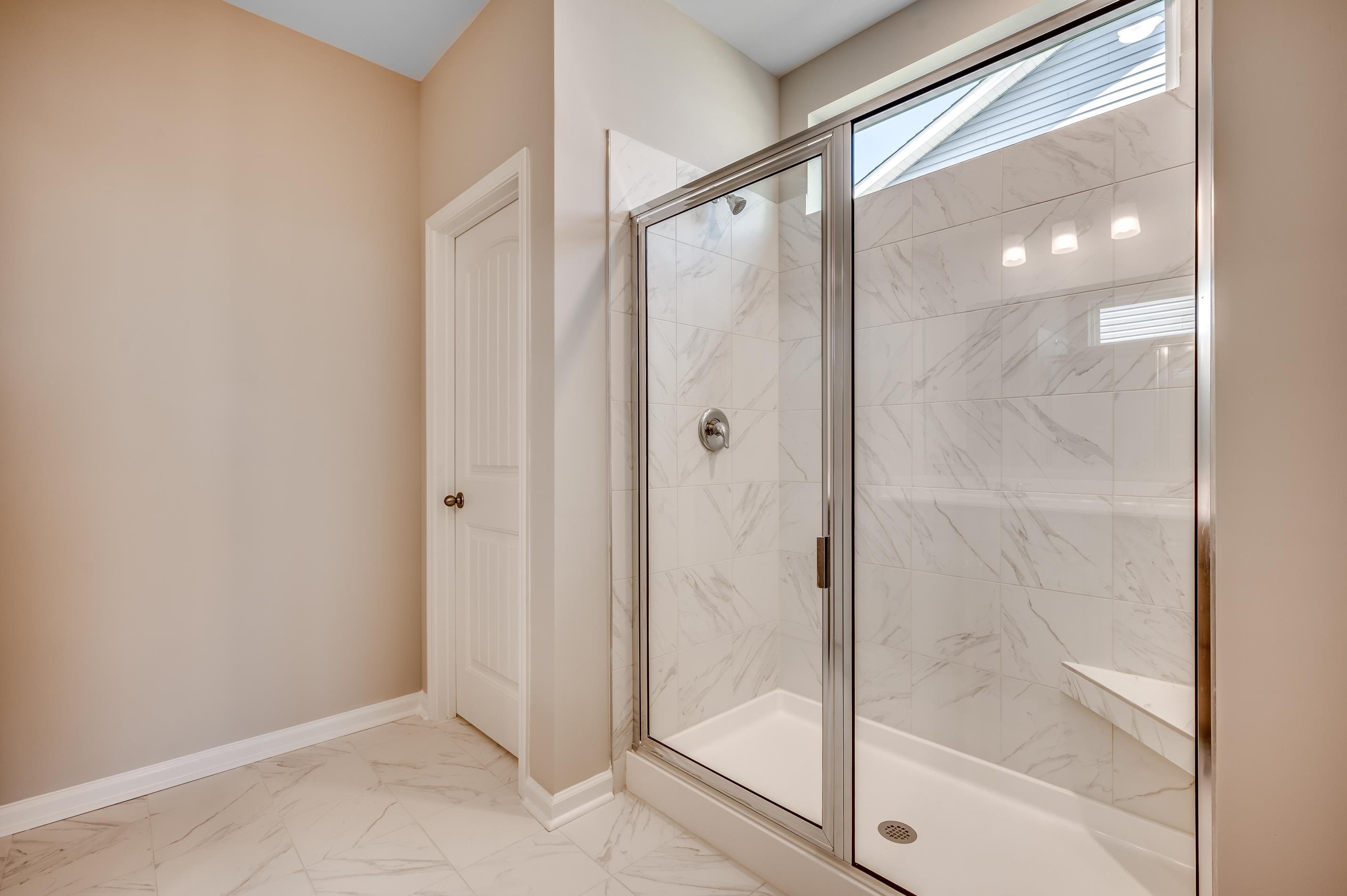 3 Buckingham Drive Loris, SC 29569 - Photo 5 of 7 Bathroom with light marble finish floors and a marble finish shower