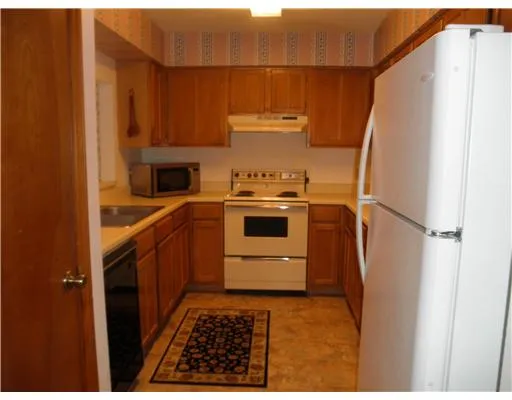 a kitchen with a stove a refrigerator and a stove