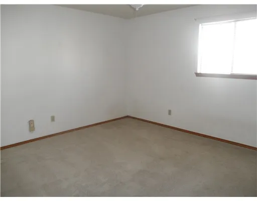 a view of an empty room and a window