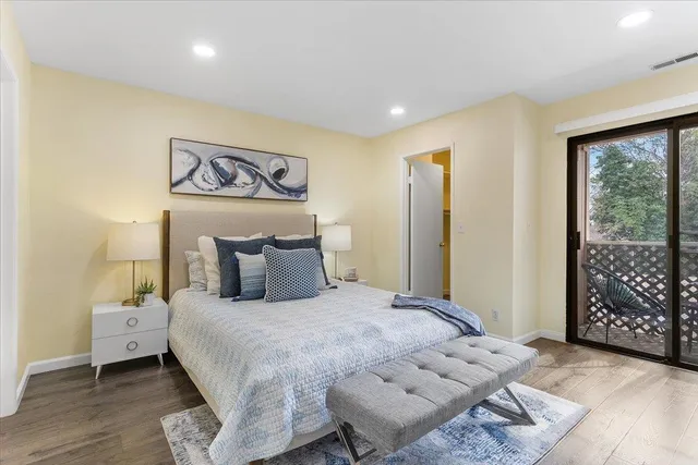 a bedroom with a bed and wooden floor