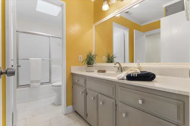 a bathroom with a double vanity sink and mirror