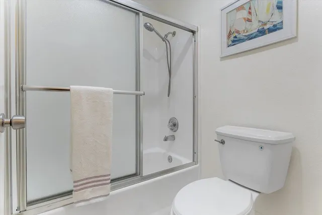 a white toilet sitting next to a bathroom