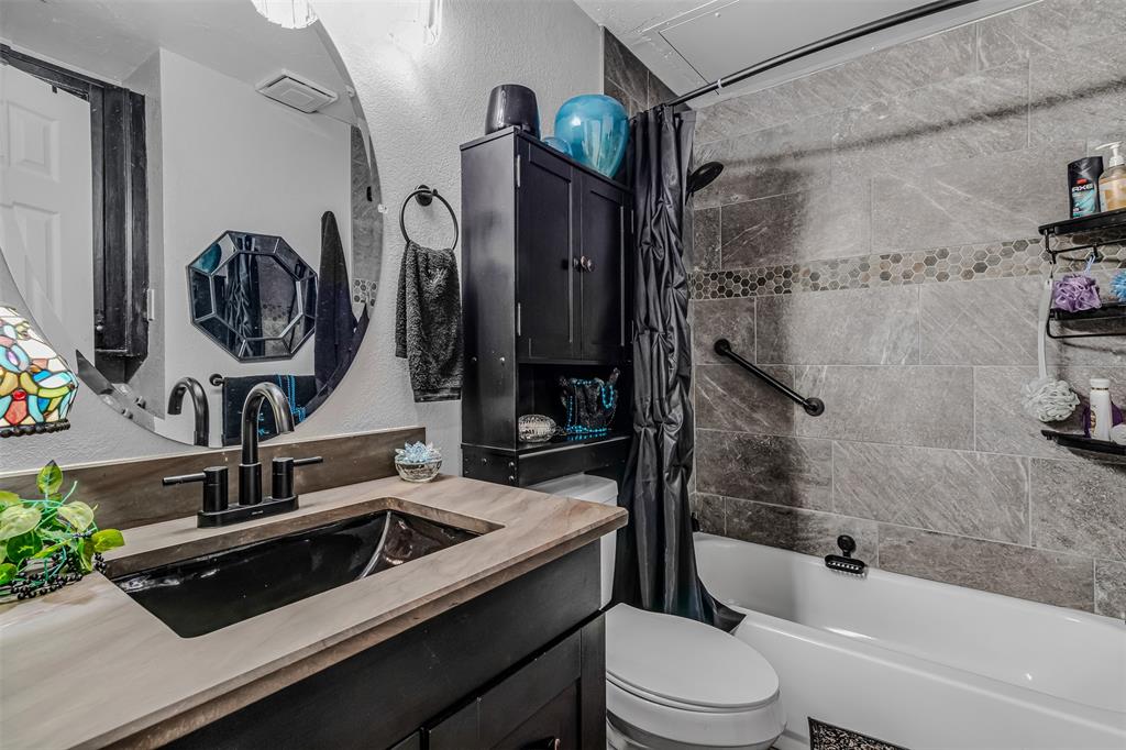 1933 Island Circle, Unit B106 Tool, TX 75143 - Photo 11 of 12 a bathroom with a sink a toilet and shower