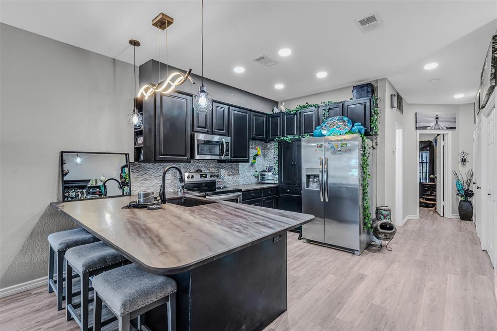 1933 Island Circle, Unit B106 Tool, TX 75143 - Photo 6 of 12 a kitchen with refrigerator cabinets dining table and chairs