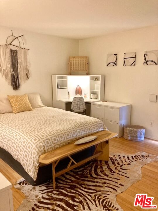 7740 Redlands Street, Unit G1098 Playa del Rey, CA 90293 - Photo 11 of 35 a bedroom with a bed and a table in it