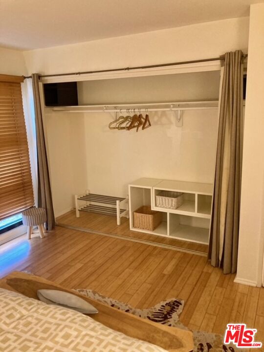7740 Redlands Street, Unit G1098 Playa del Rey, CA 90293 - Photo 12 of 35 a view of an empty room with wooden floor and a window