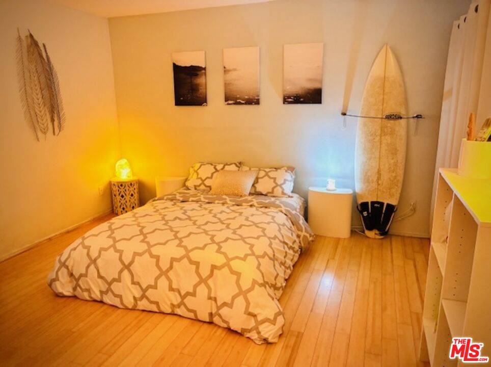 7740 Redlands Street, Unit G1098 Playa del Rey, CA 90293 - Photo 16 of 35 a bedroom with a bed and wooden floor