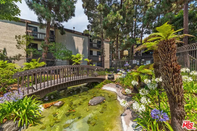 a view of a house with a flower garden