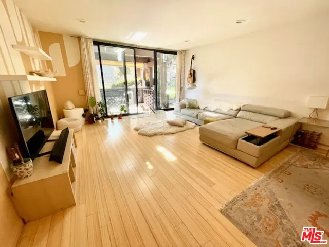 a living room with furniture and large windows